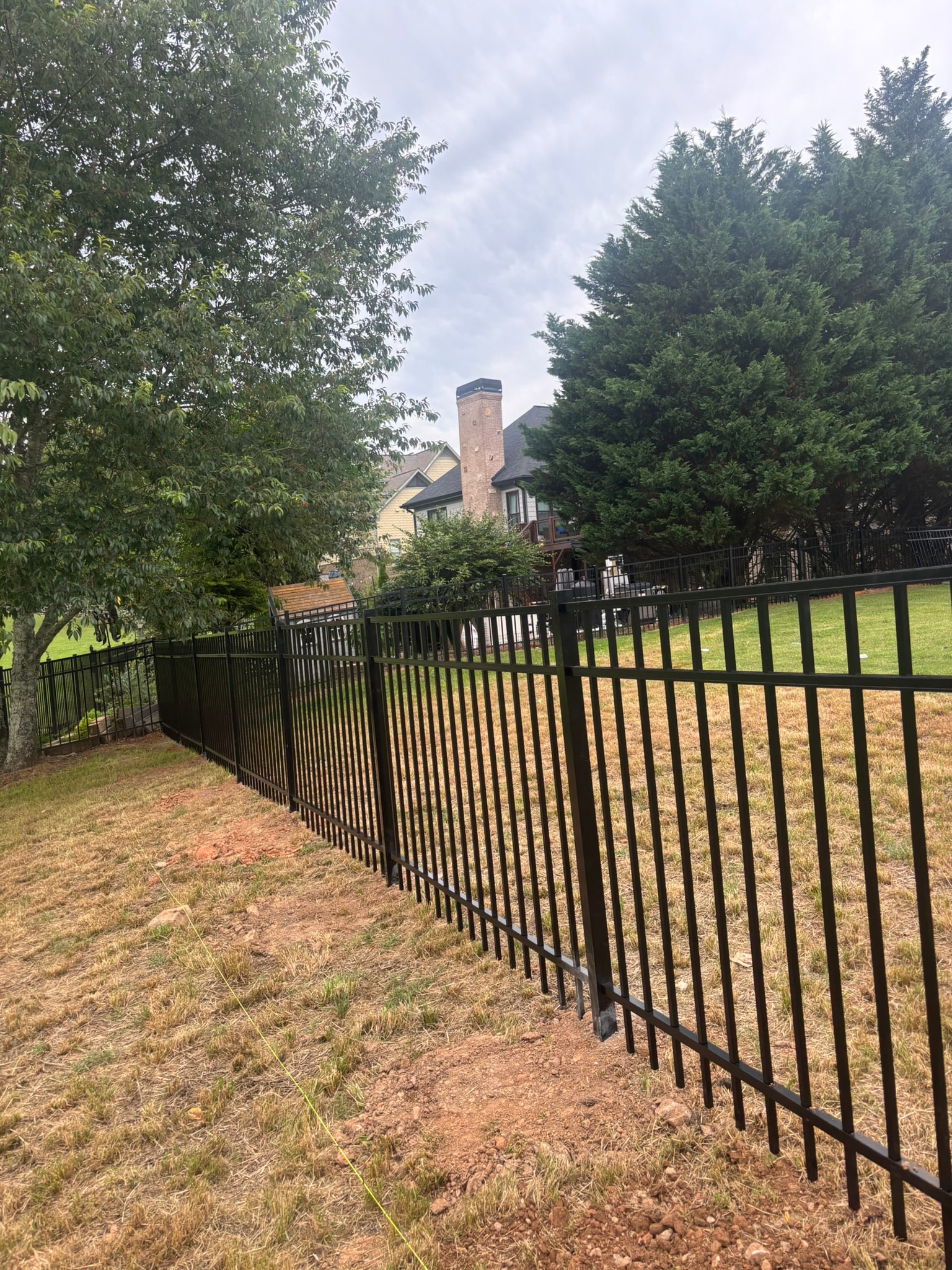 Black metal fence surrounding residential property