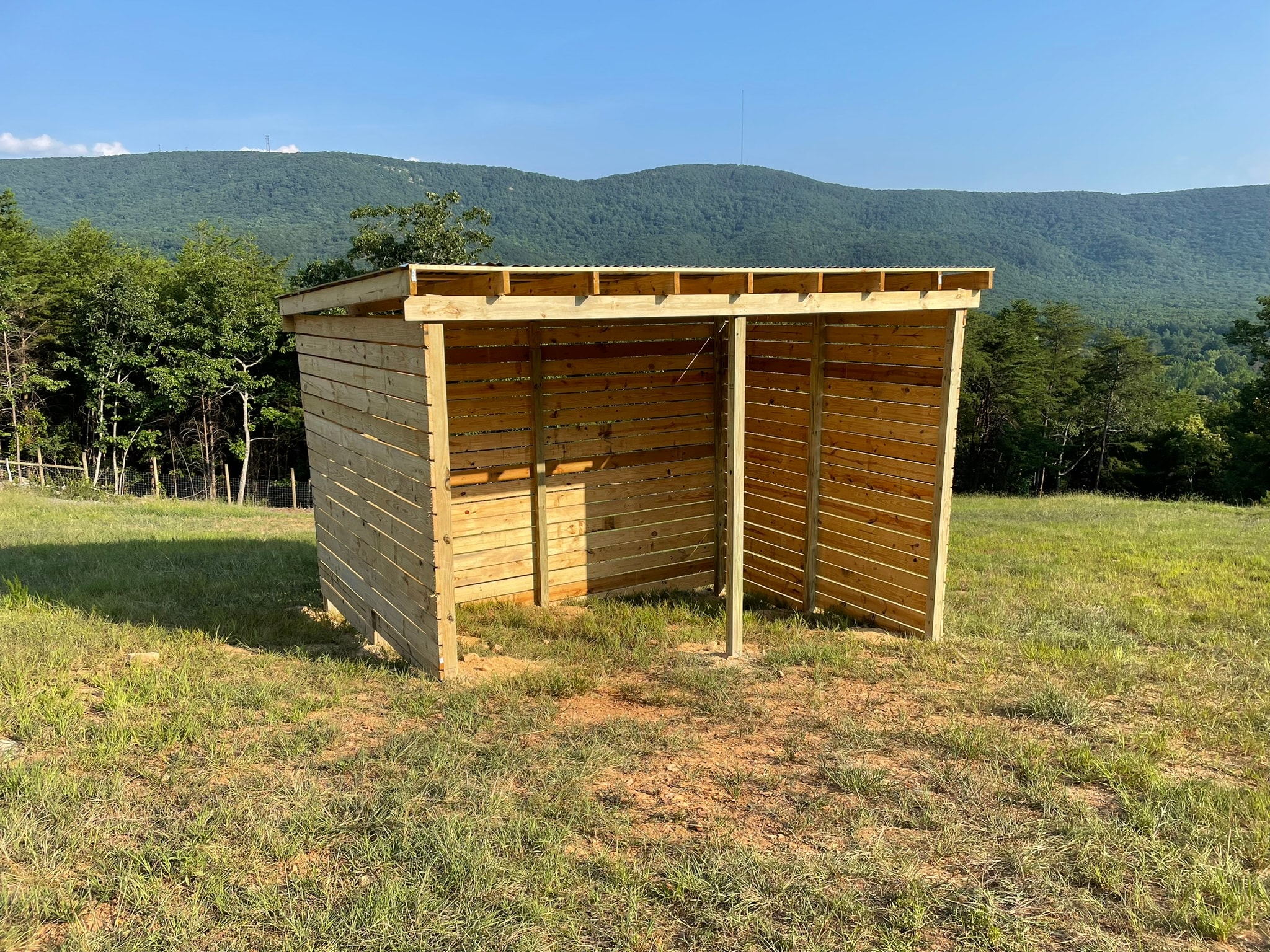 Wooden shelter in mountain meadow