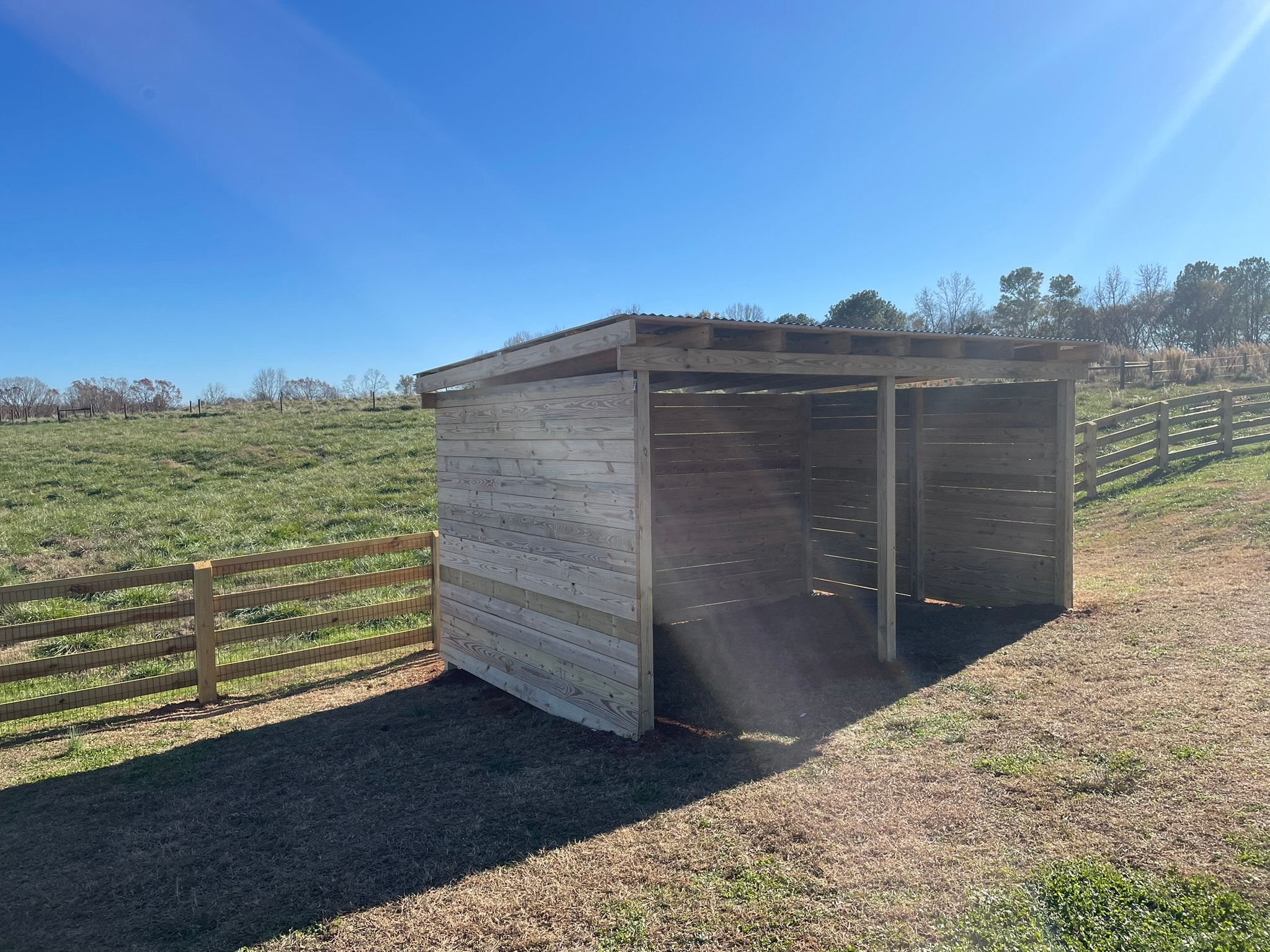 Wooden shelter in rural pasture