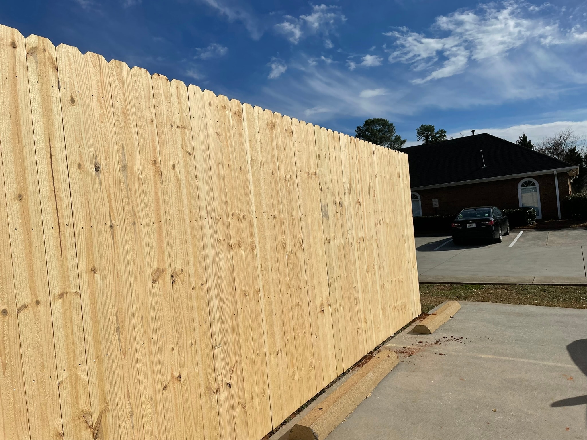 New wooden fence at residential driveway