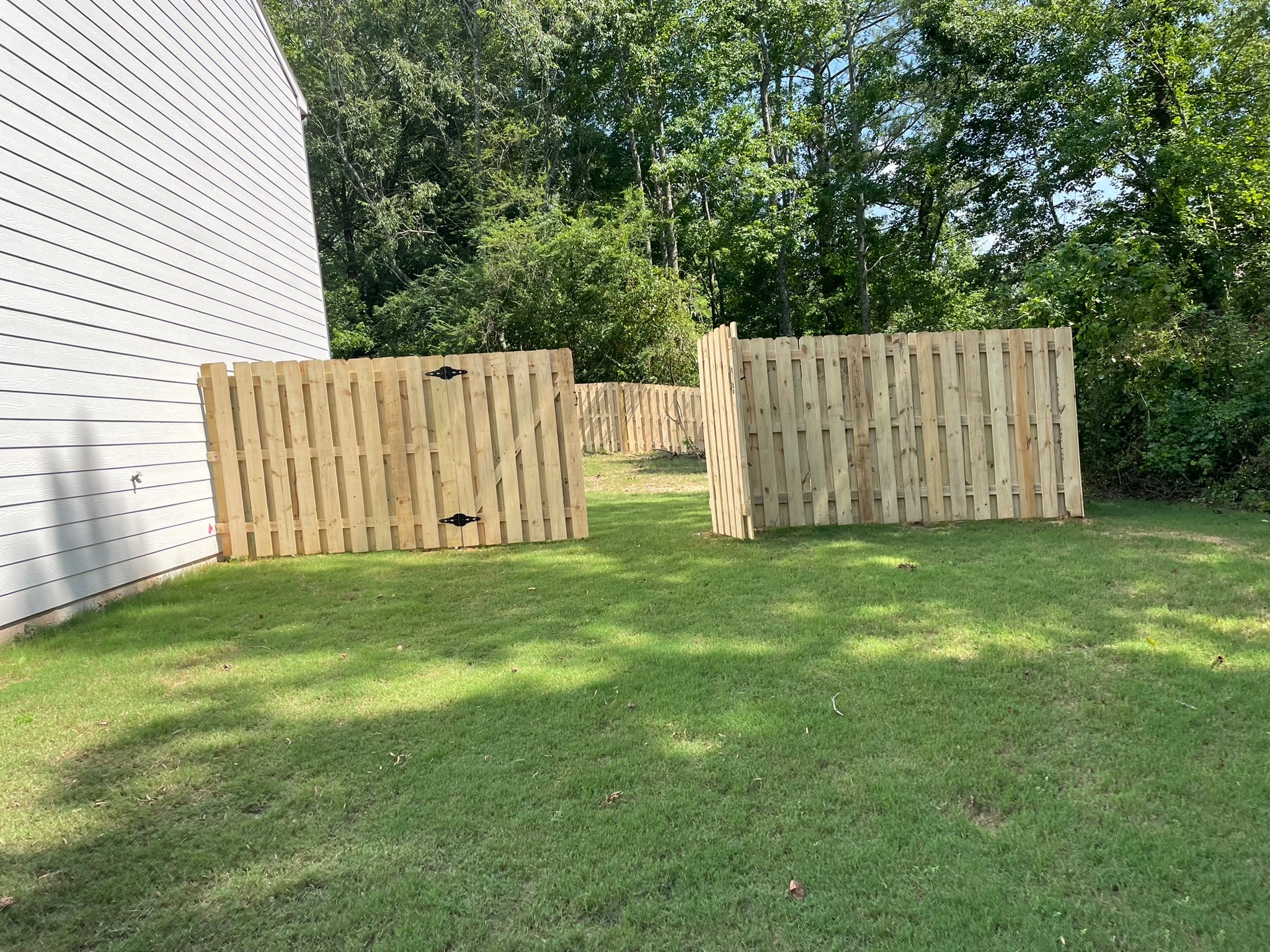 Wooden fence gates in backyard lawn